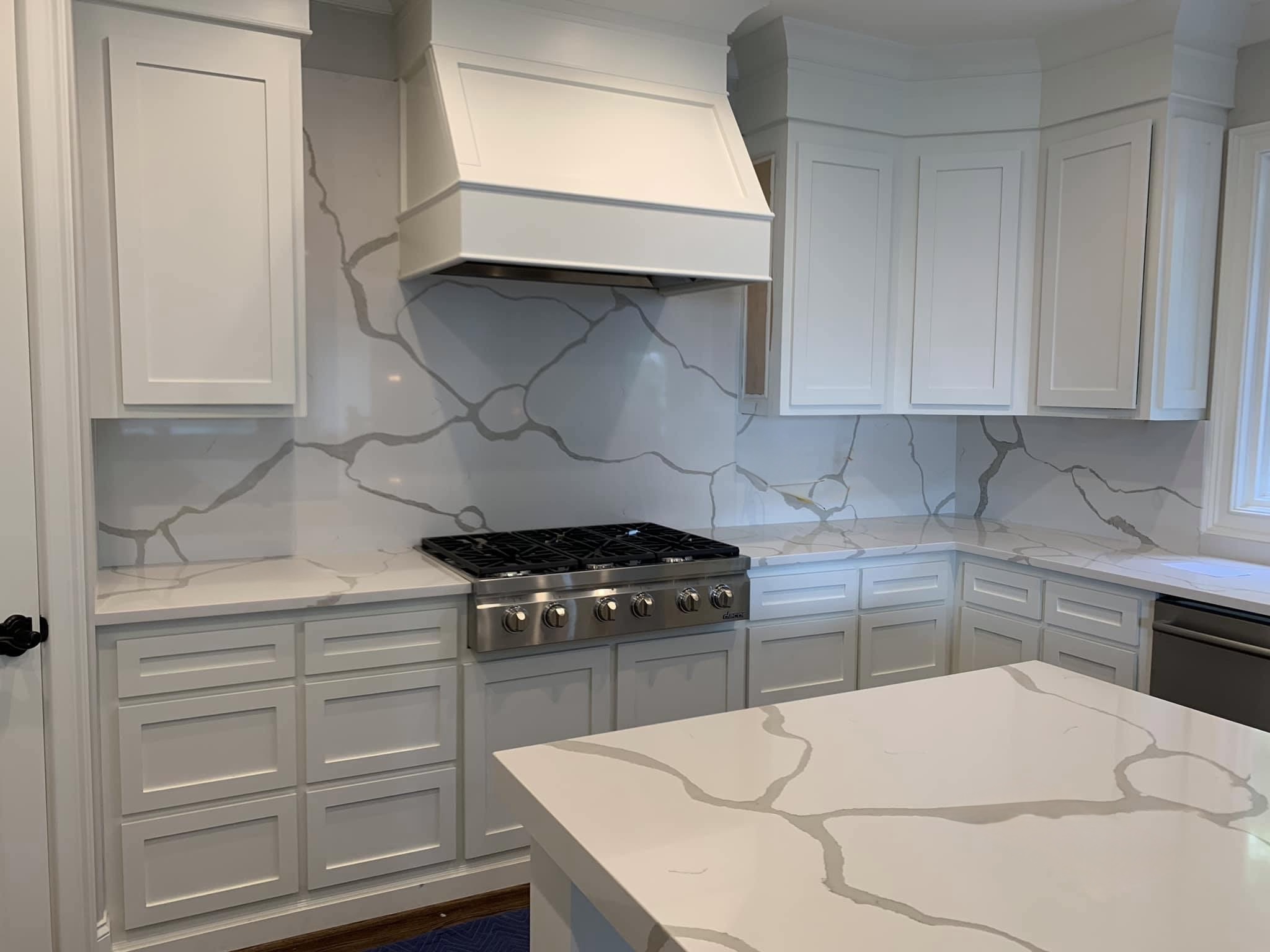 Solo Granite Beautifule marble kitchen remodel with marble backsplash and hood vent