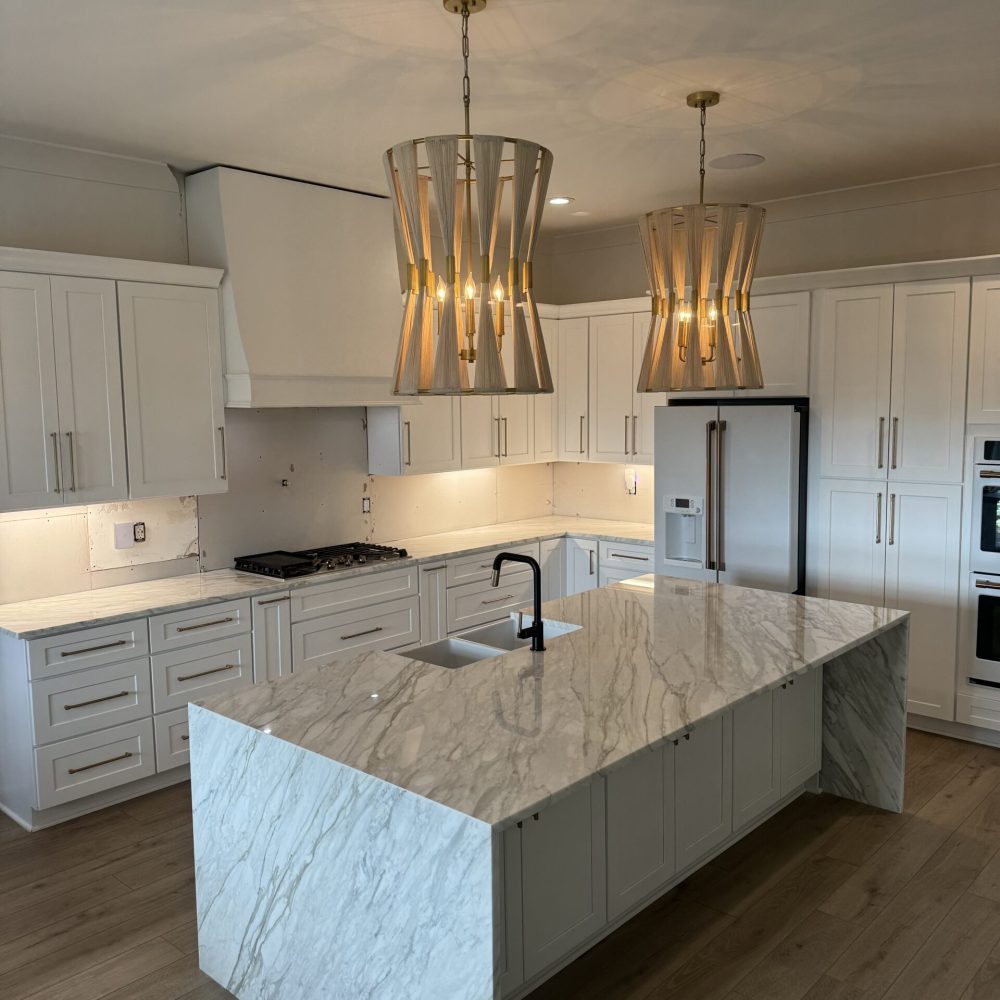 Contemporary kitchen with white marble countertops and clean finish