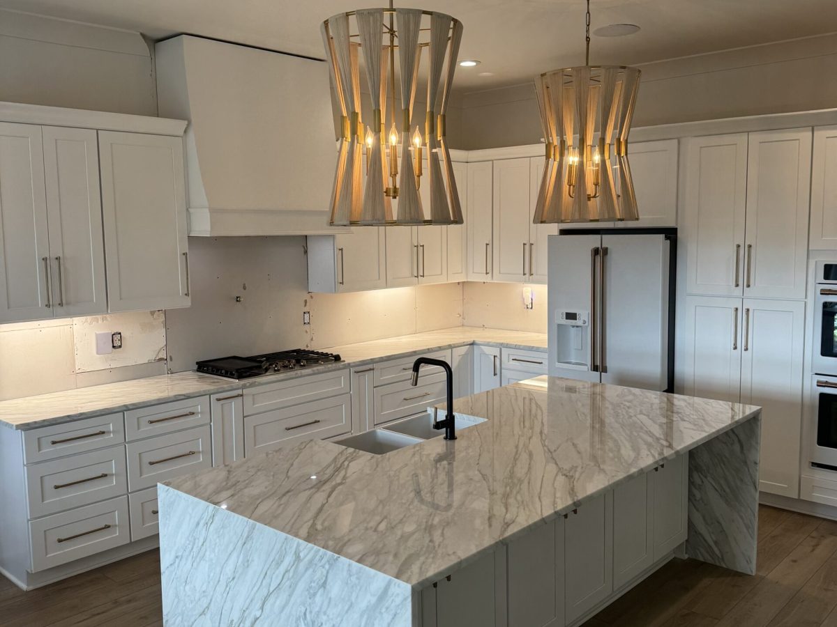 Contemporary kitchen with white marble countertops and clean finish